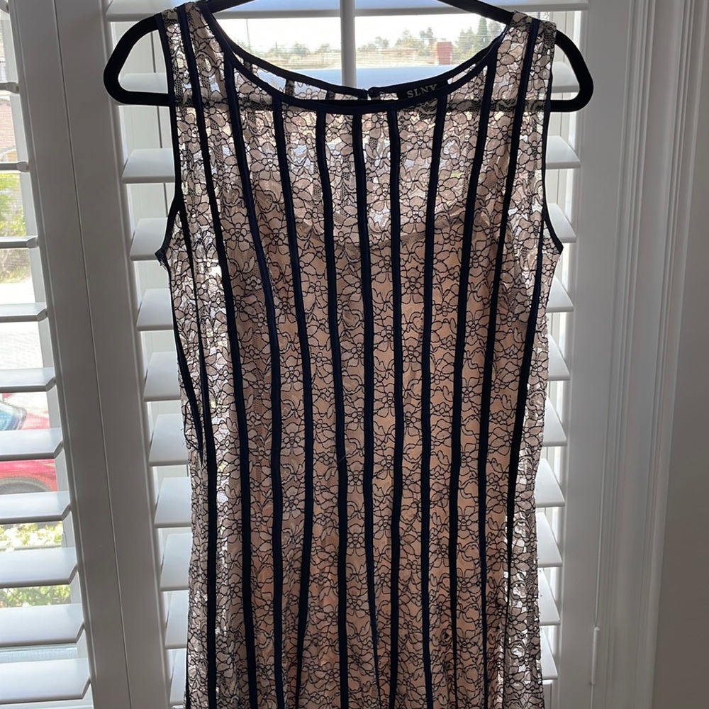 Nude and navy colored dress with navy satin striped and lace floral nude flowers